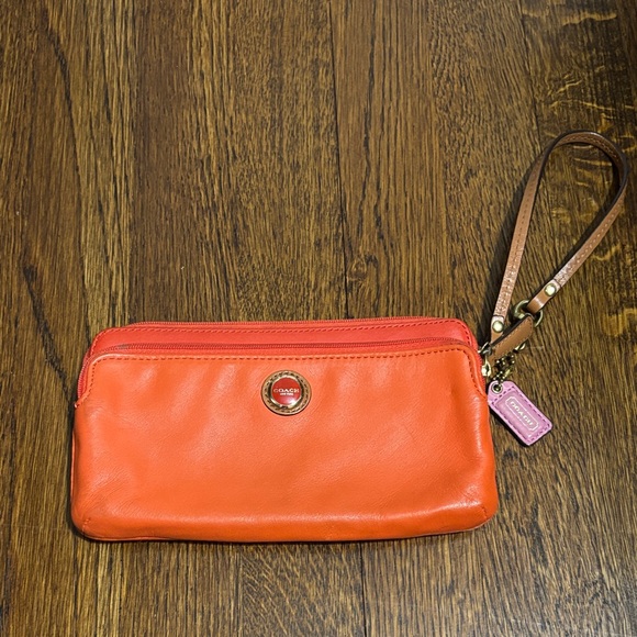 Coach Handbags - Coach Orange Leather Wristlet with Pink Charm and Brown Strap